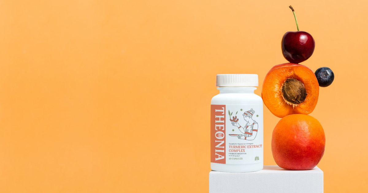A white bottle of "THEONIA" Turmeric Extract Complex capsules next to a stack of fruit (cherry, apricot, blueberry, mango) on an orange background.
