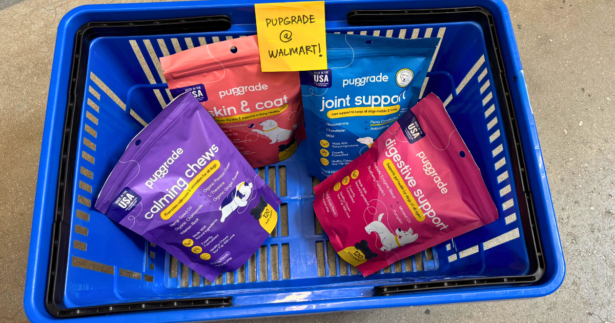 A blue shopping basket containing four "PUPGRADE" brand dog supplement packets with a sticky note reading "PUPGRADE @ WALMART!"