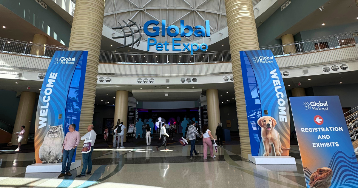 Entrance to the Global Pet Expo with people walking through.