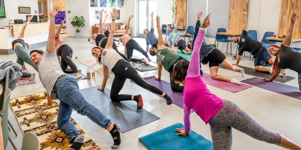 Diverse individuals participating in a yoga class for health and well-being.