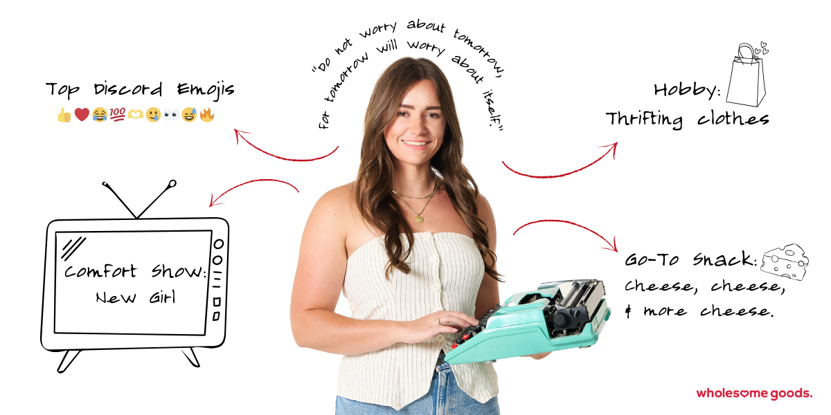 Rachel Beland, Content Writer at Wholesome Goods, holding a turquoise typewriter with doodles of her favorite emojis and personal touches.